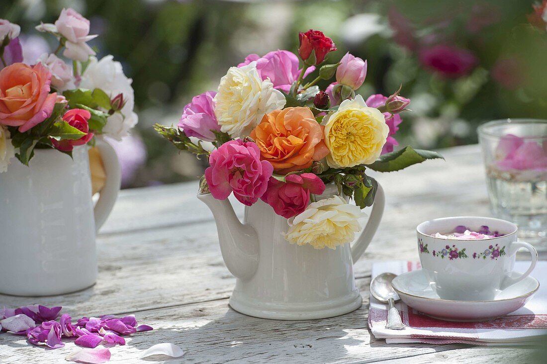 Mixed pinks (roses) from the garden in pots as vases