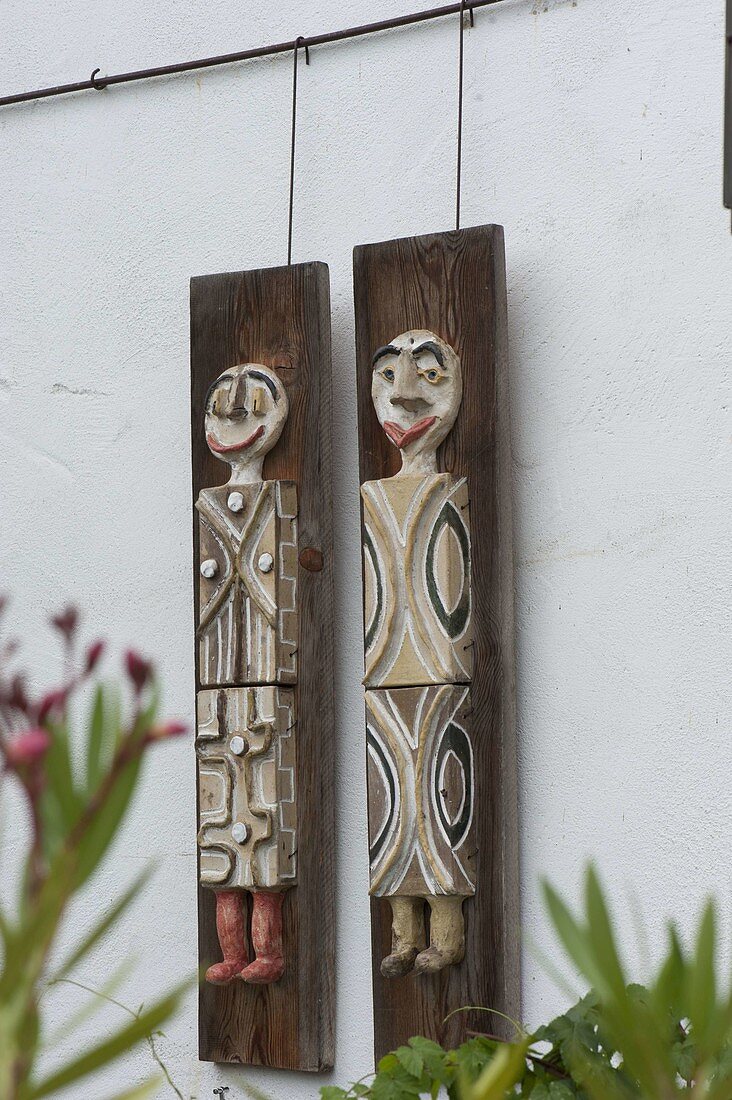 Pottery figures hung on wooden planks