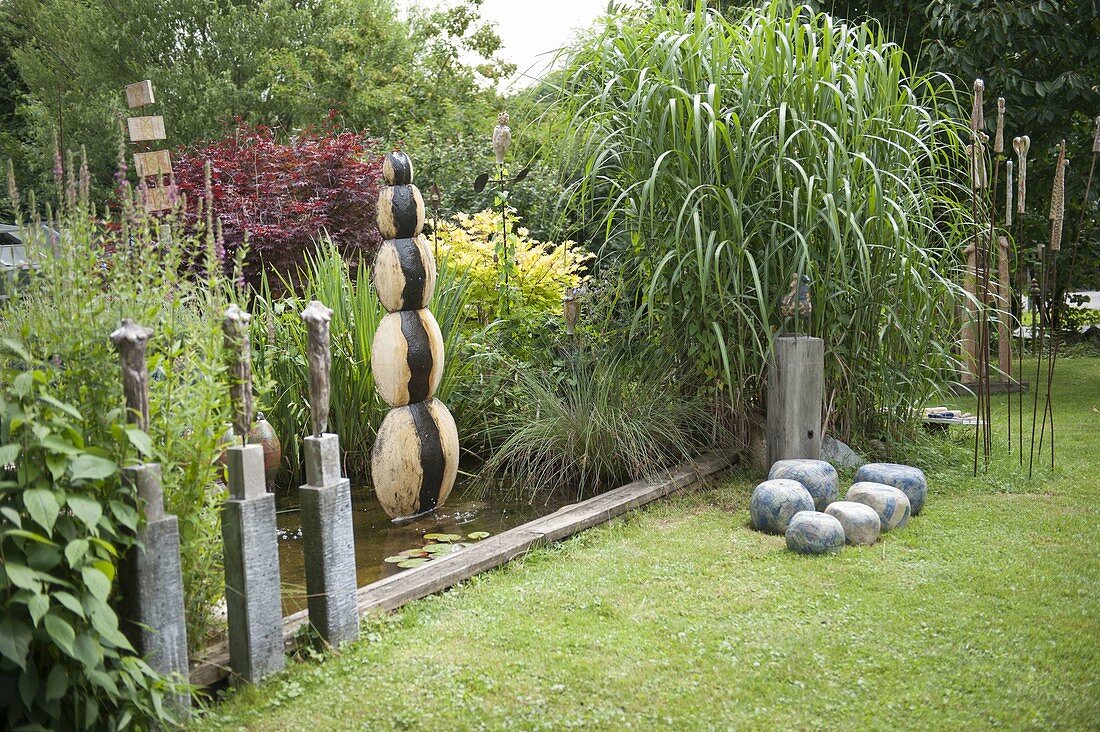 Garden with pottery art objects and water feature