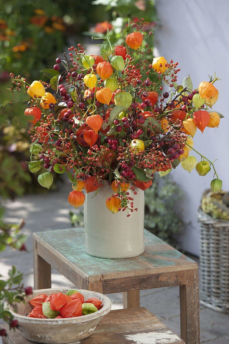 Autumn bouquet of wild fruits and physalis, roses