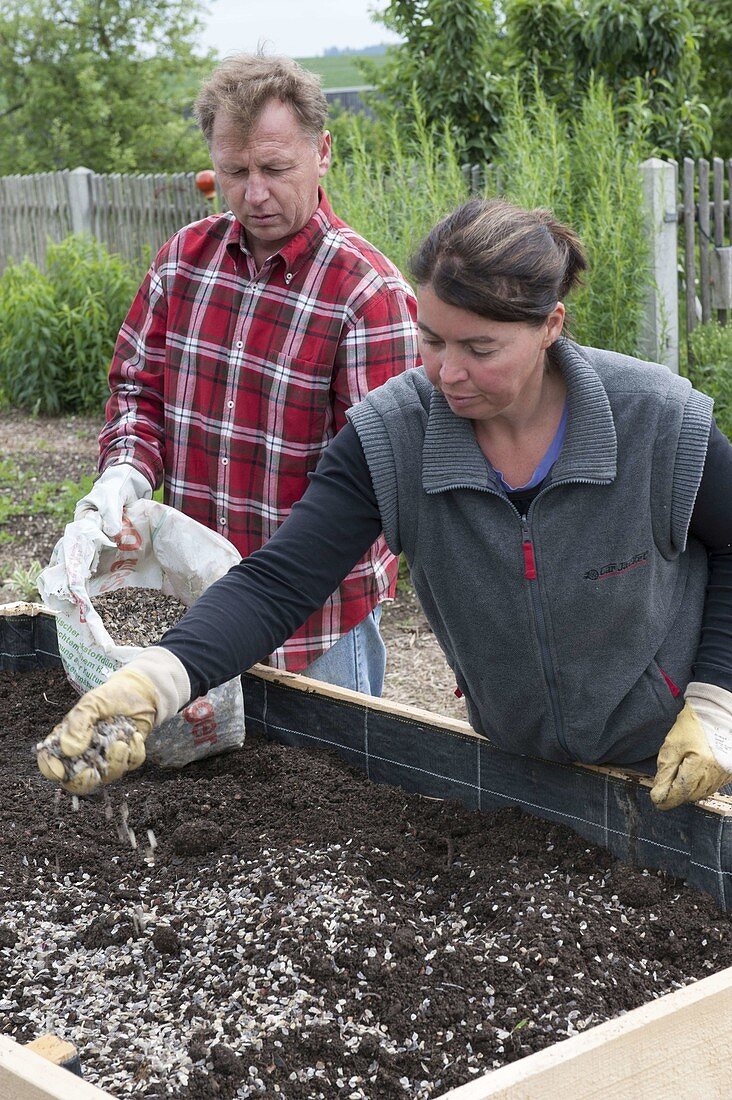 Build a raised flower bed of boards