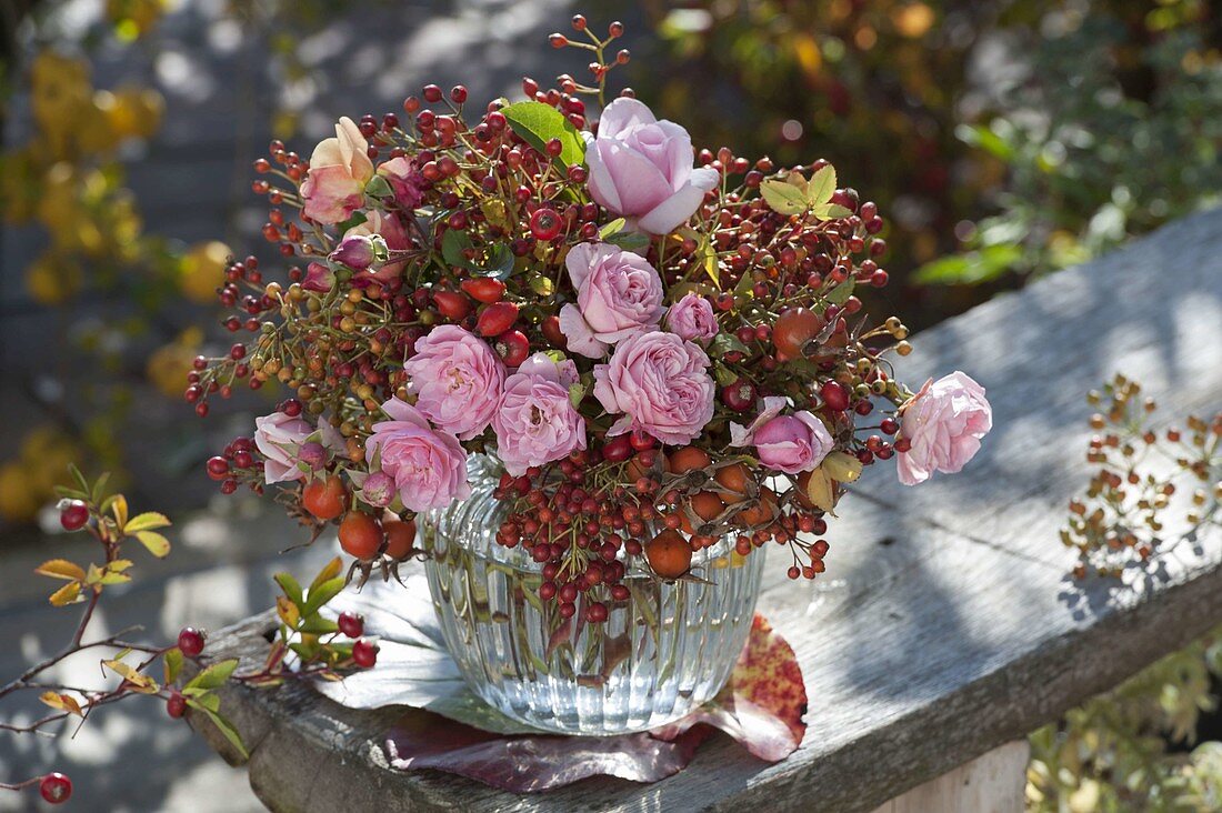 Autumn bouquet of pink (roses) and various rose hips