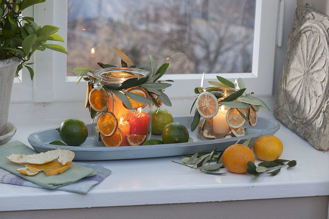 Canning jars as lanterns at the window, decorated with twigs of olea