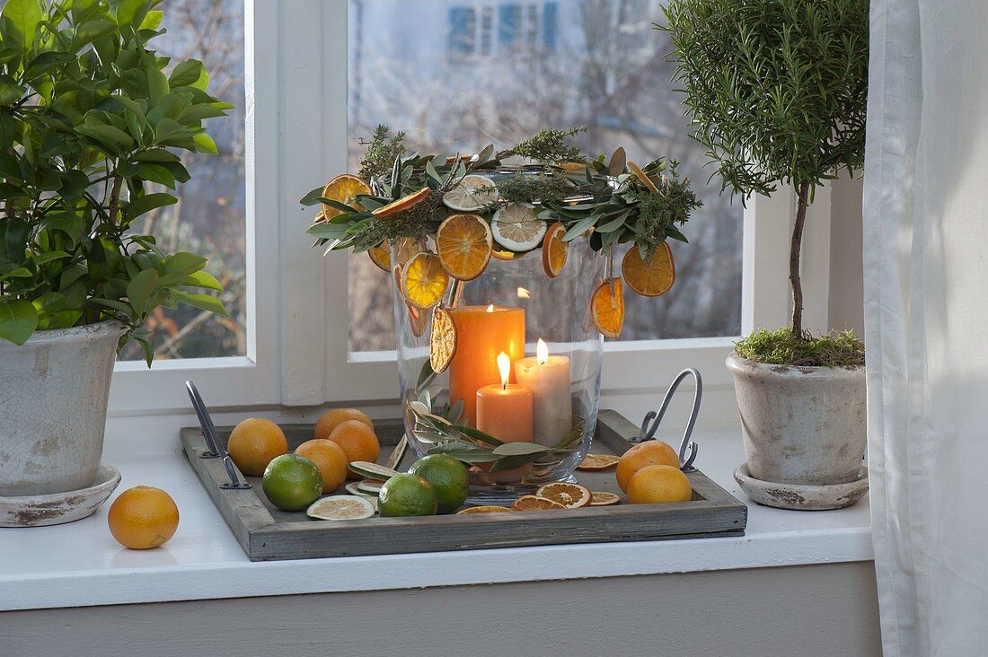 Large glass lantern with citrus (orange slices), wreath