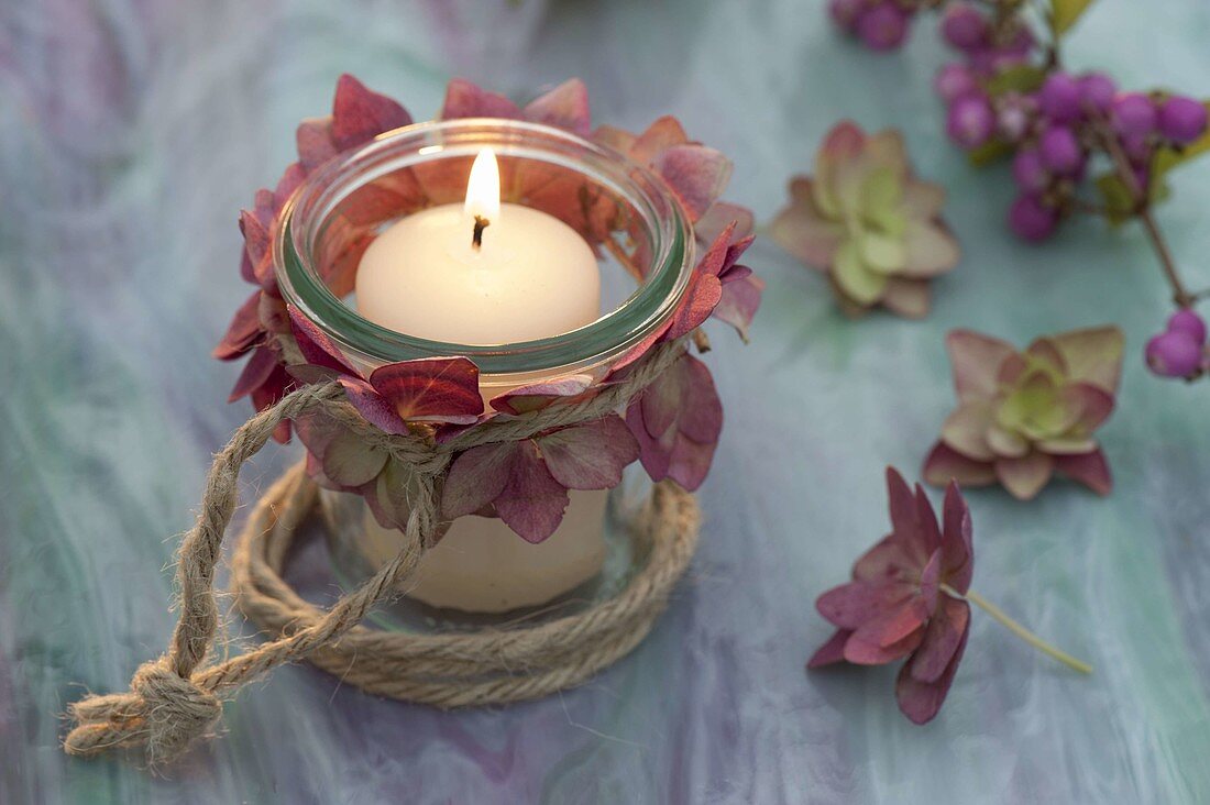 Small lantern with hydrangea (hydrangea) blossoms and burlap string