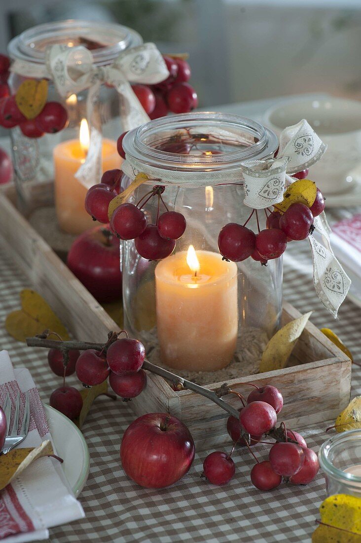 Table decoration with ornamental apples and apples