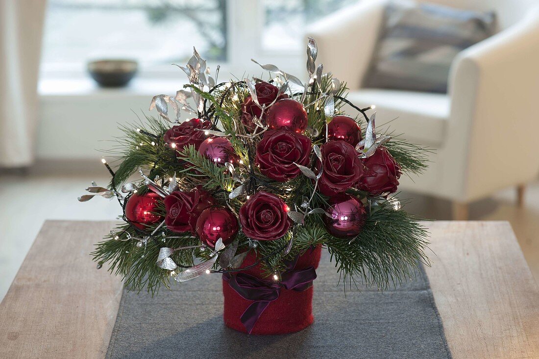 Christmas bouquet with fairy lights and waxed roses