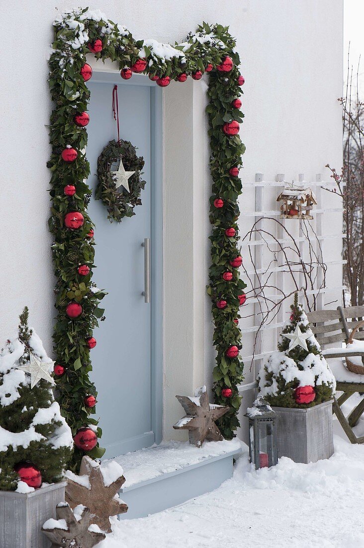 Decorate front door with garland for Christmas