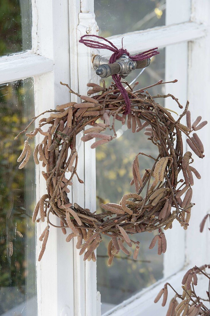 Wreath made from branches of Corylus avellana (hazelnut) at the window