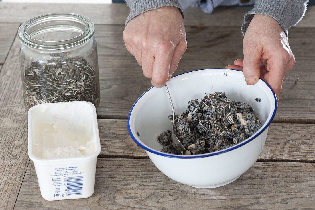 Birdseed in different containers to hang up