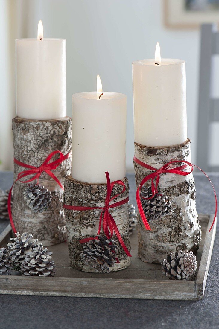 Birch trunks as candle holders for white candles