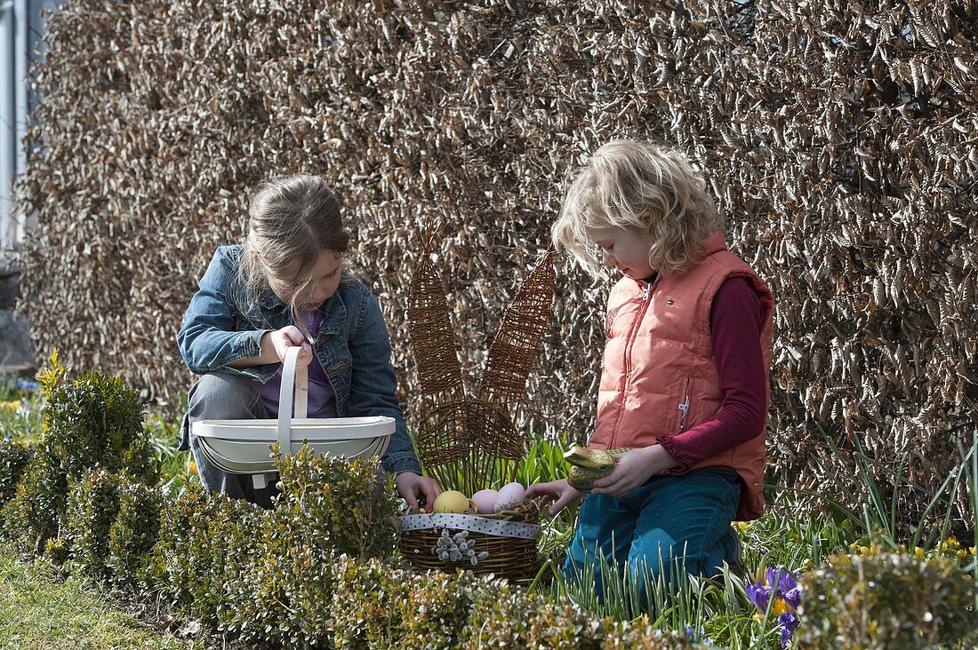 Girl with chip basket and homemade Easter basket with hare's head