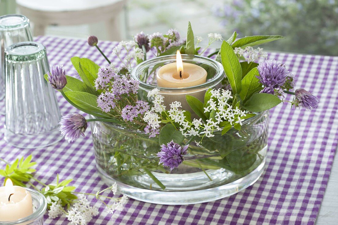 Lantern with flowers of woodruff (Galium odoratum), chives