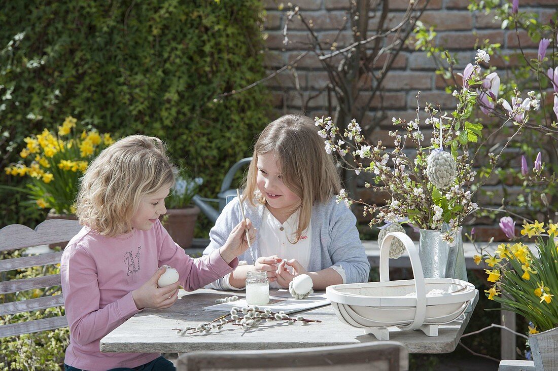 Children making and painting Easter eggs