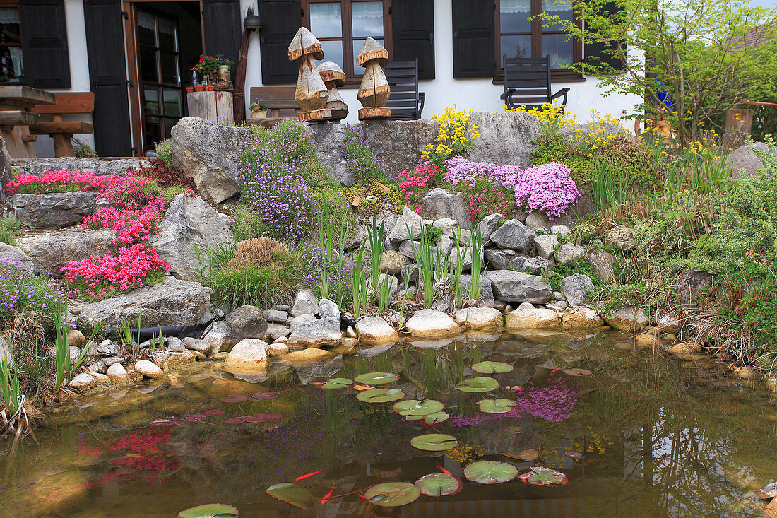 Rock garden with coarse natural stones by the garden pond