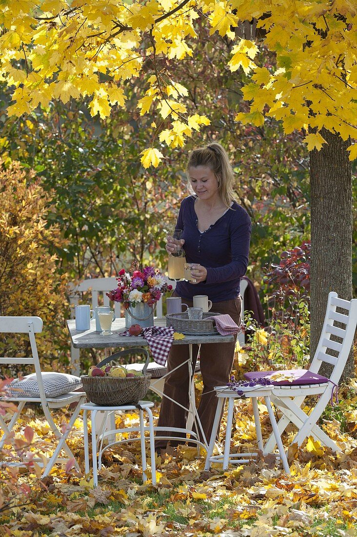 Set table under maple tree with golden yellow leaves