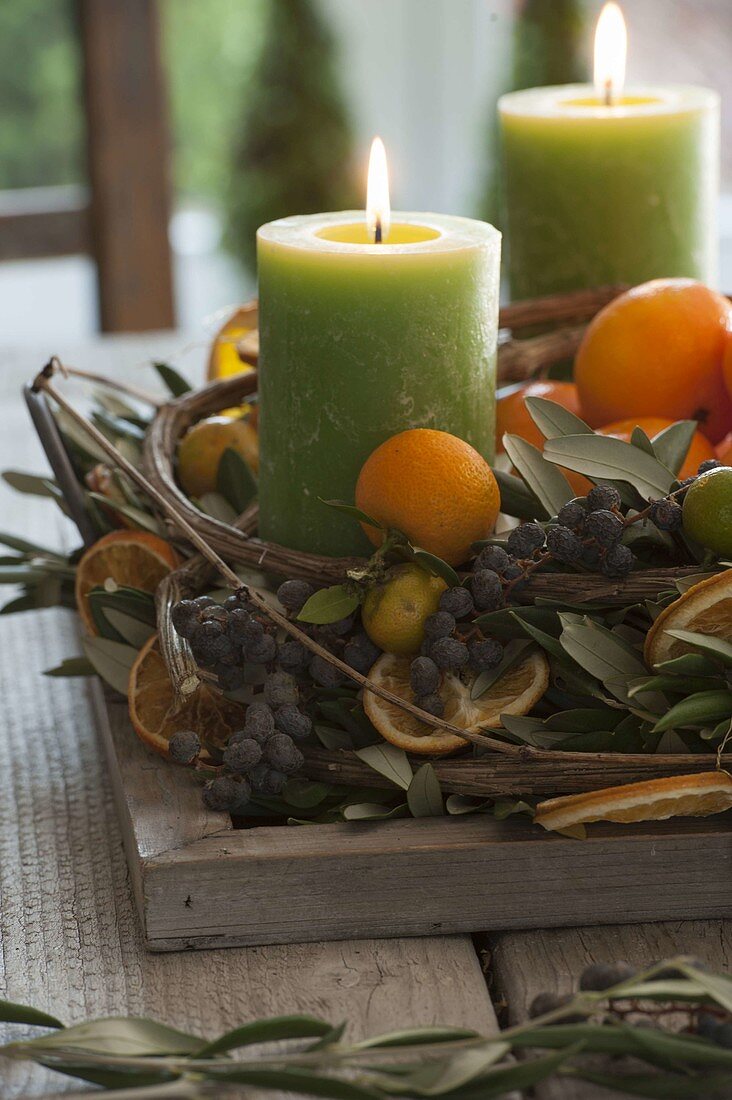 Mediterranean Advent wreath with olive branches, black dates, mandarins