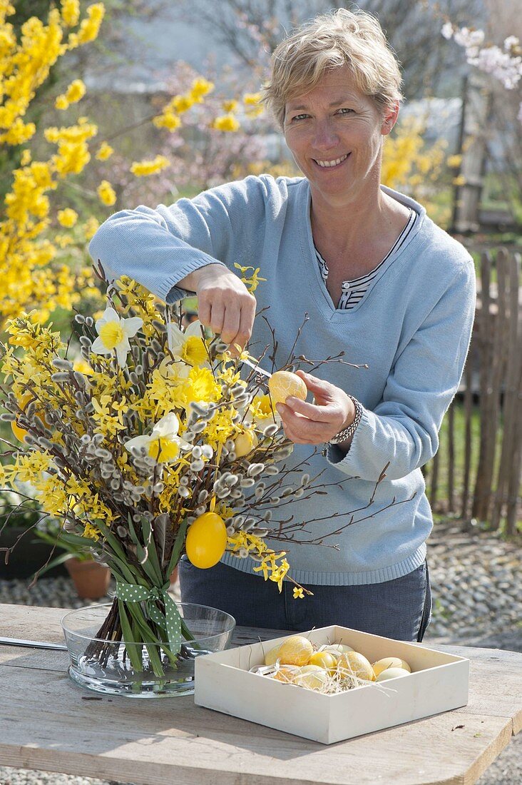 Woman decorates Easter bouquet