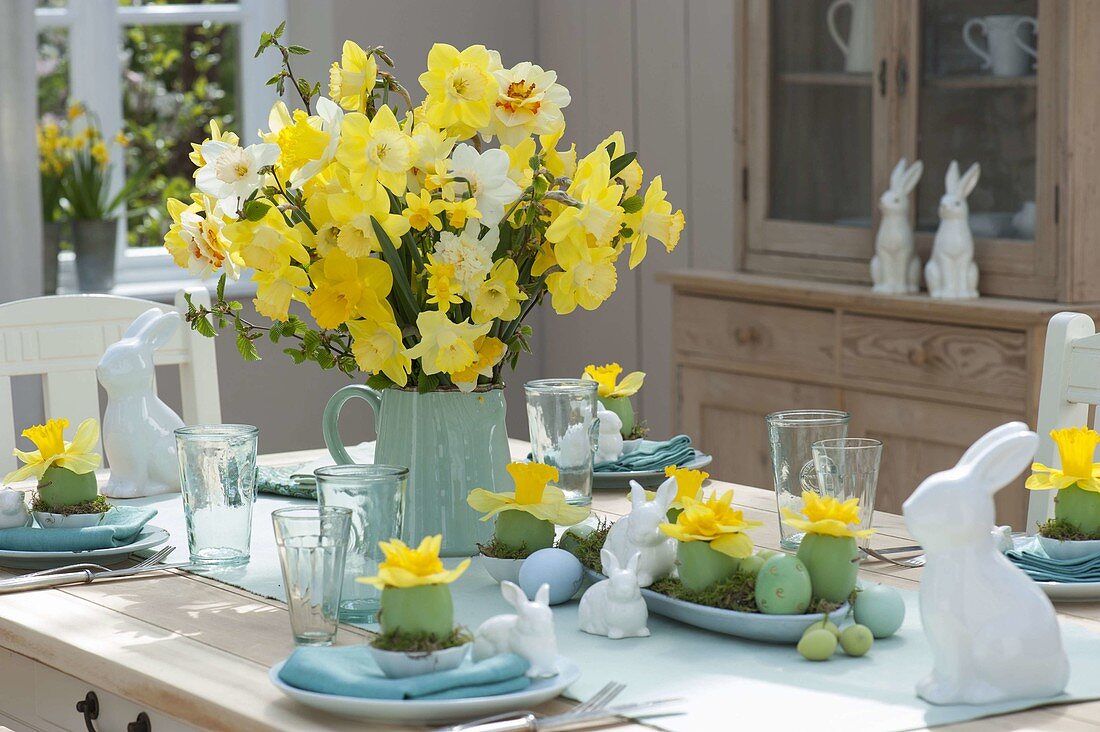 Easter table decoration with narcissus and easter bunny