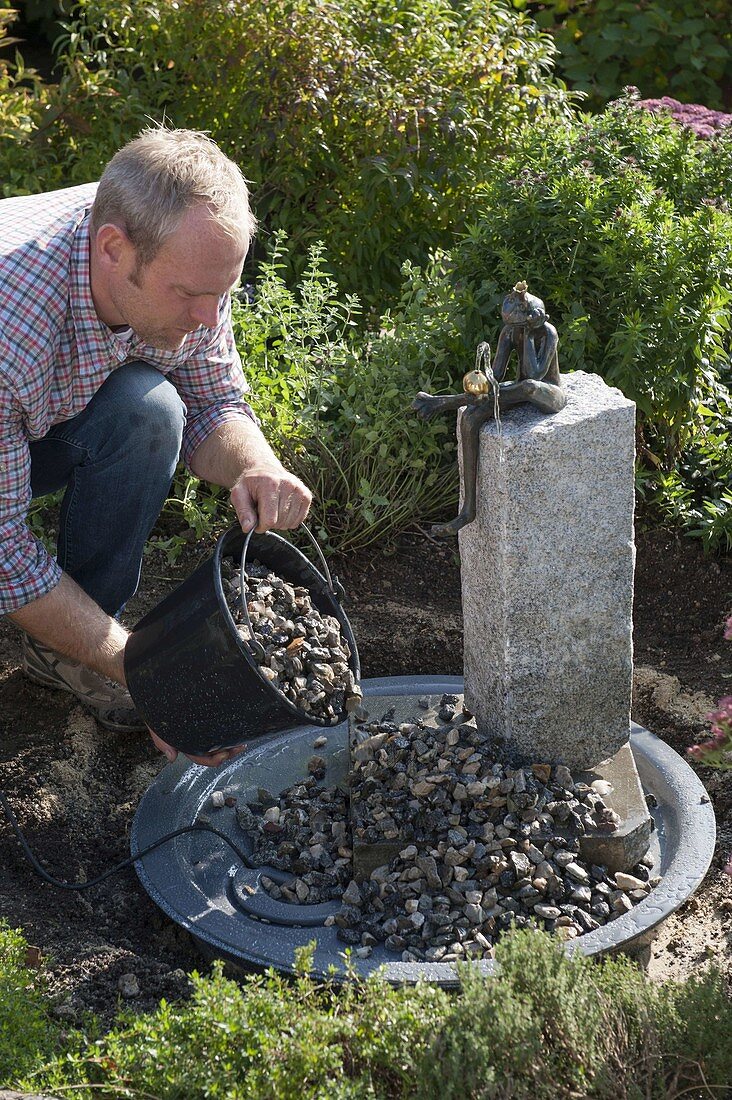 Build up water game with frog on granite pillar