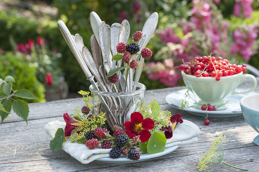 Preserving jar with cutlery in wreath of blackberries (Rubus), fennel