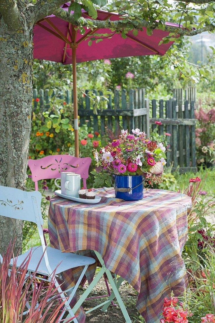 Woman covering table under apple tree