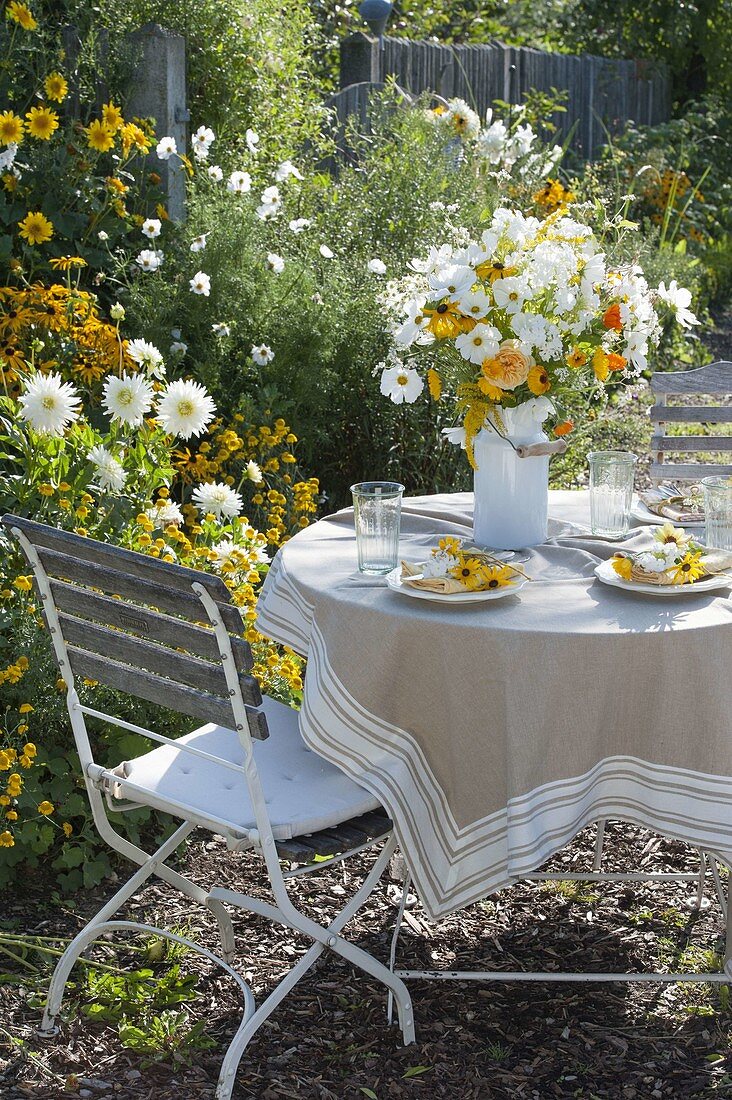 Small seat at the yellow and white bed with Dahlia 'My Love'