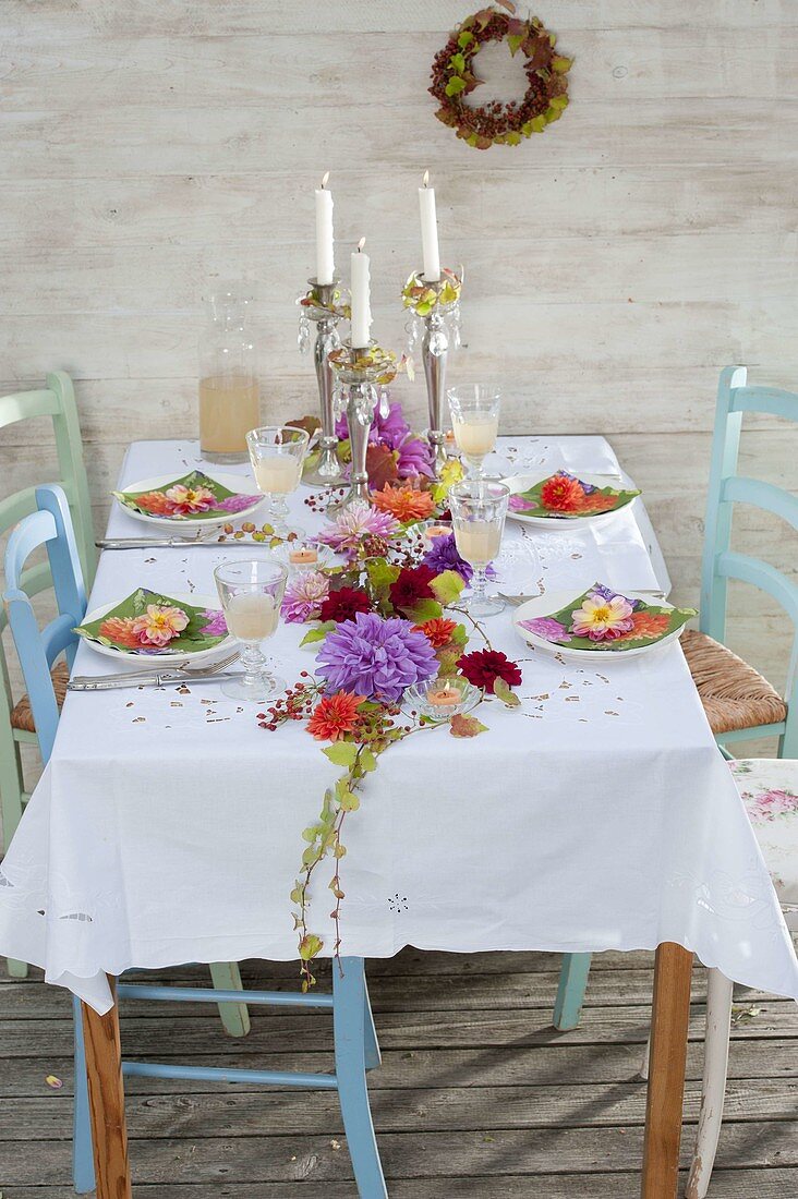 Table decoration with garland of flowers of Dahlia