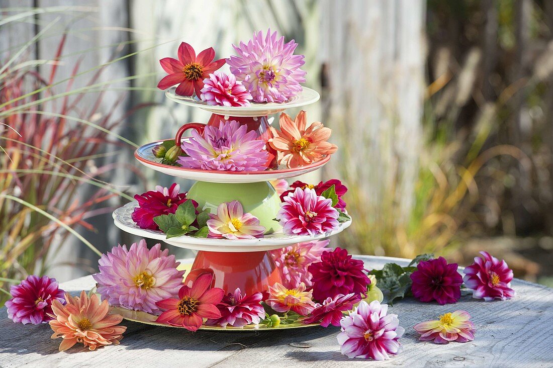 Etagere made from plates and cups, decorated with flowers
