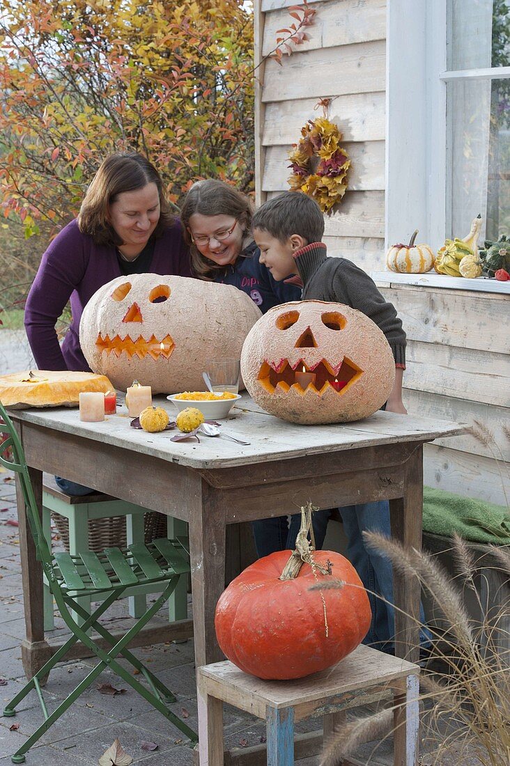 Family carving pumpkins for Halloween