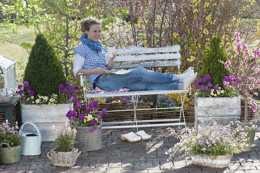 Spring terrace with planted containers and garden bench