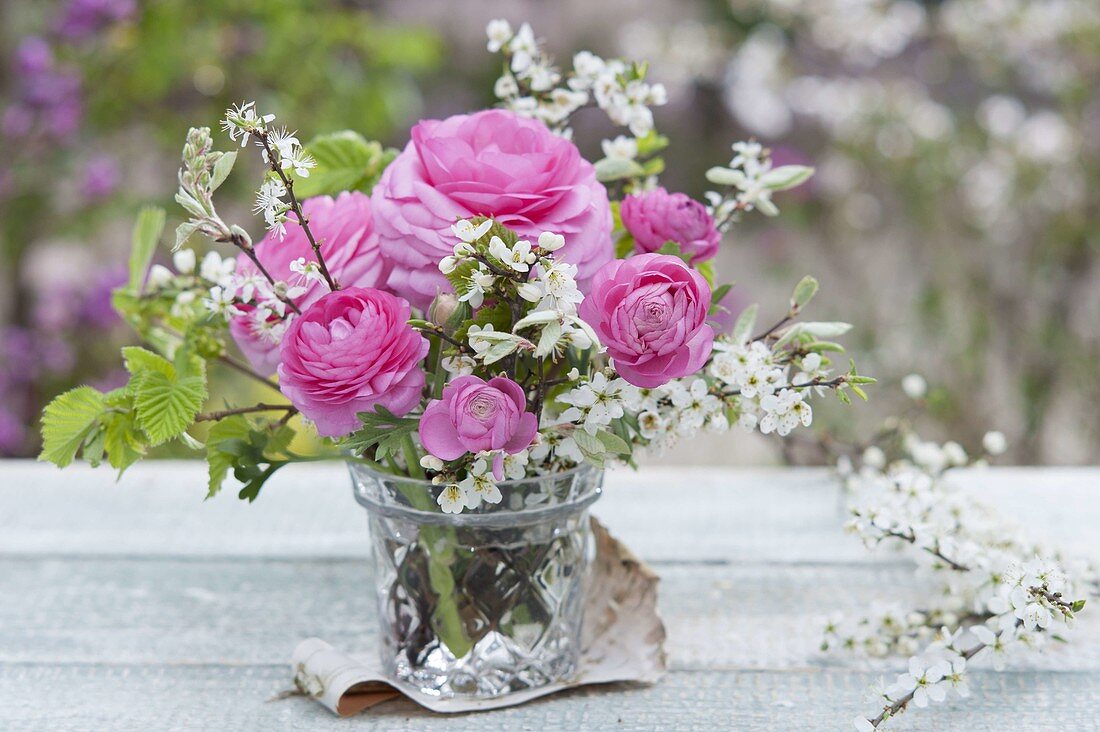 Small bouquet of ranunculus and prunus branches