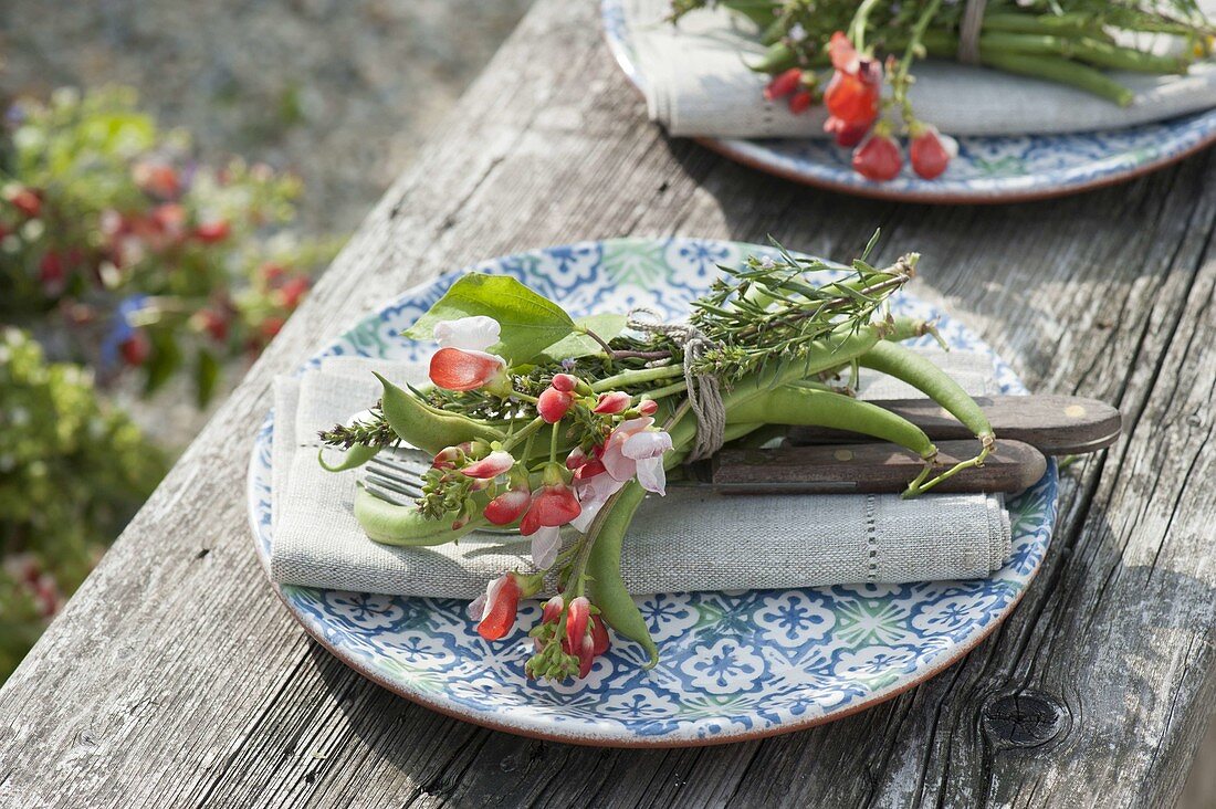 Napkin decoration with vegetables and herbs, beans and flowers