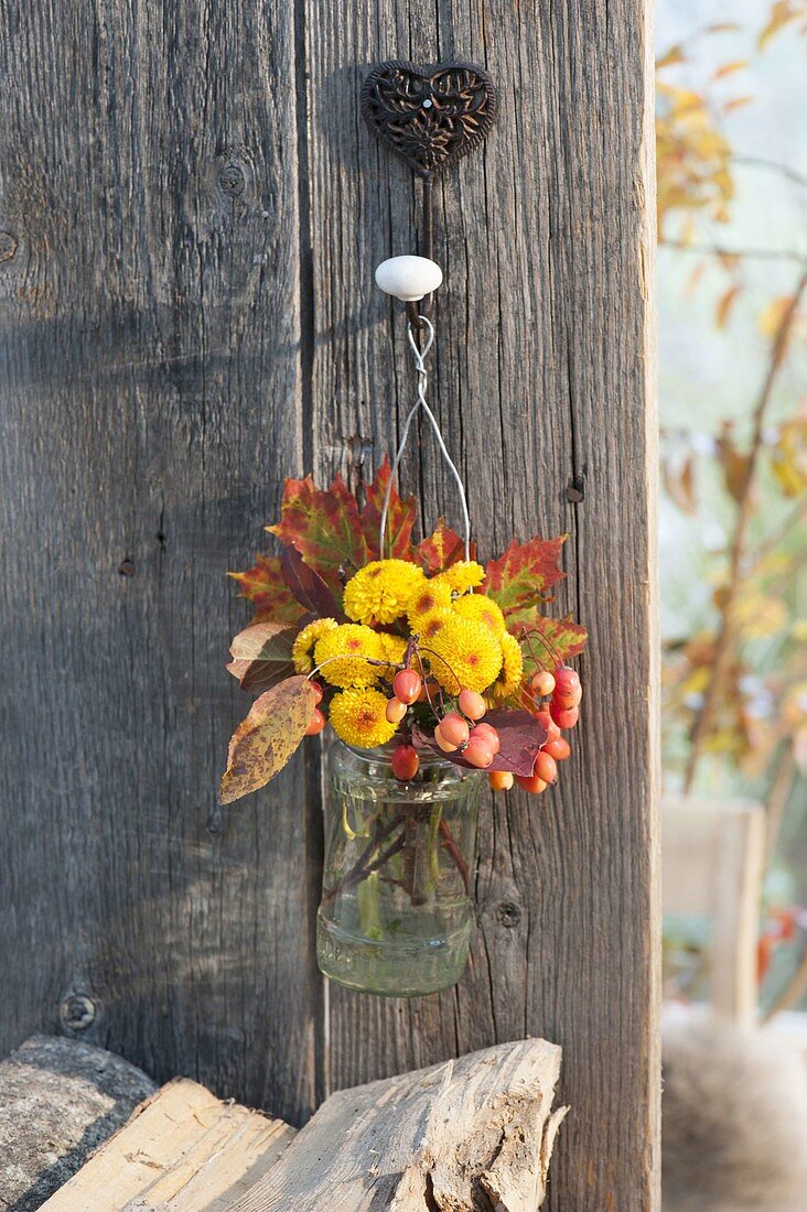Small bouquet of chrysanthemum, autumn leaves