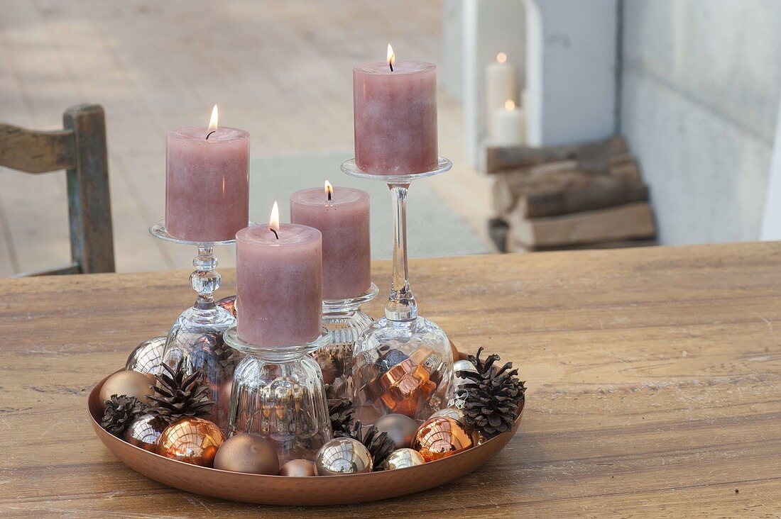 Unusual Advent decoration with candles on inverted glasses