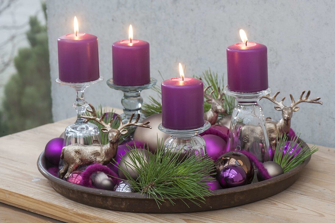 Unusual Advent wreath with candles on inverted glasses