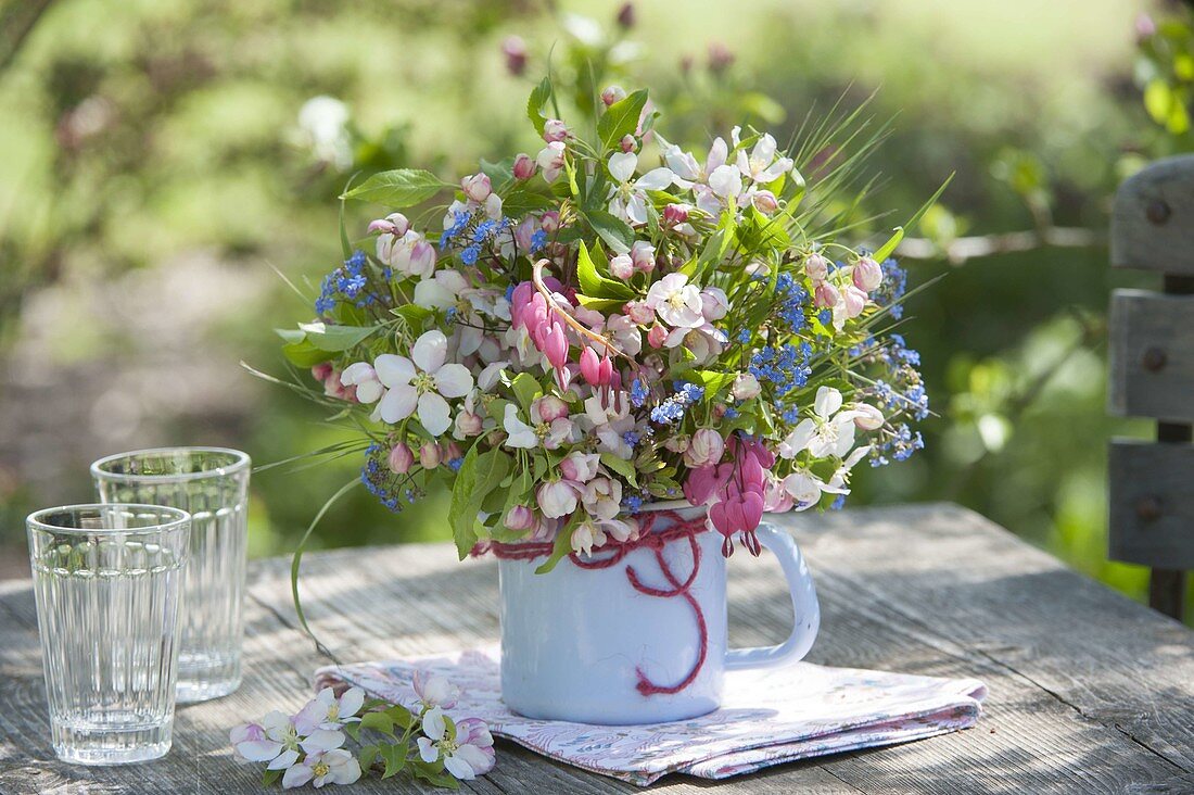 Small bouquet in enamel pot, Malus (ornamental apple), Brunnera