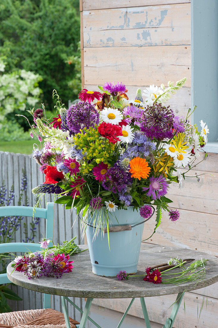 Colorful cottage garden bouquet in enameled bucket