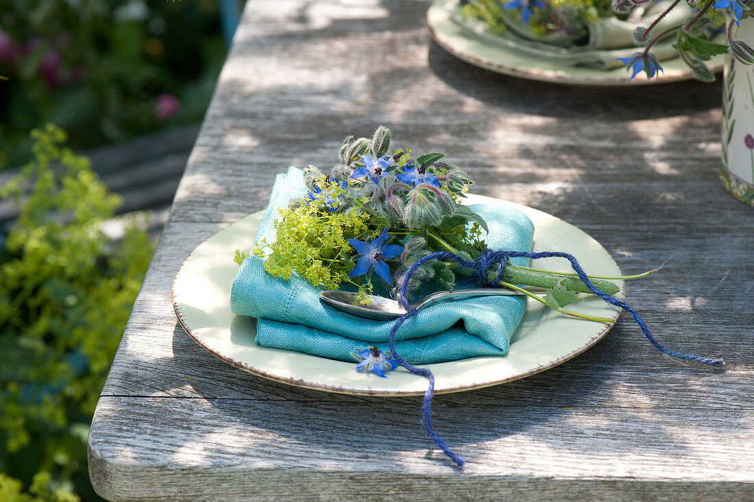 Small table decoration with borage, alchemilla