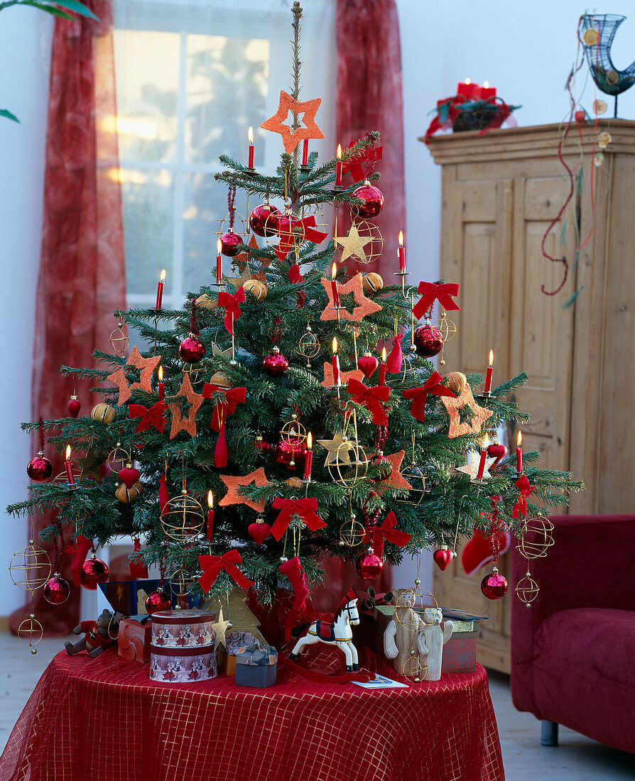 Nordmann fir decorated with balls, candles and stars