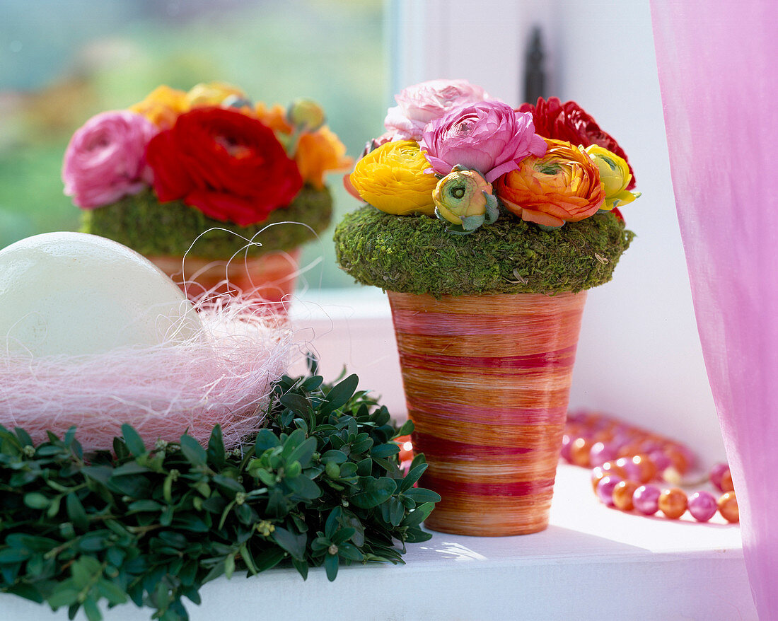 Bouquet with ranunculus, moss ring, beech wreath with egg