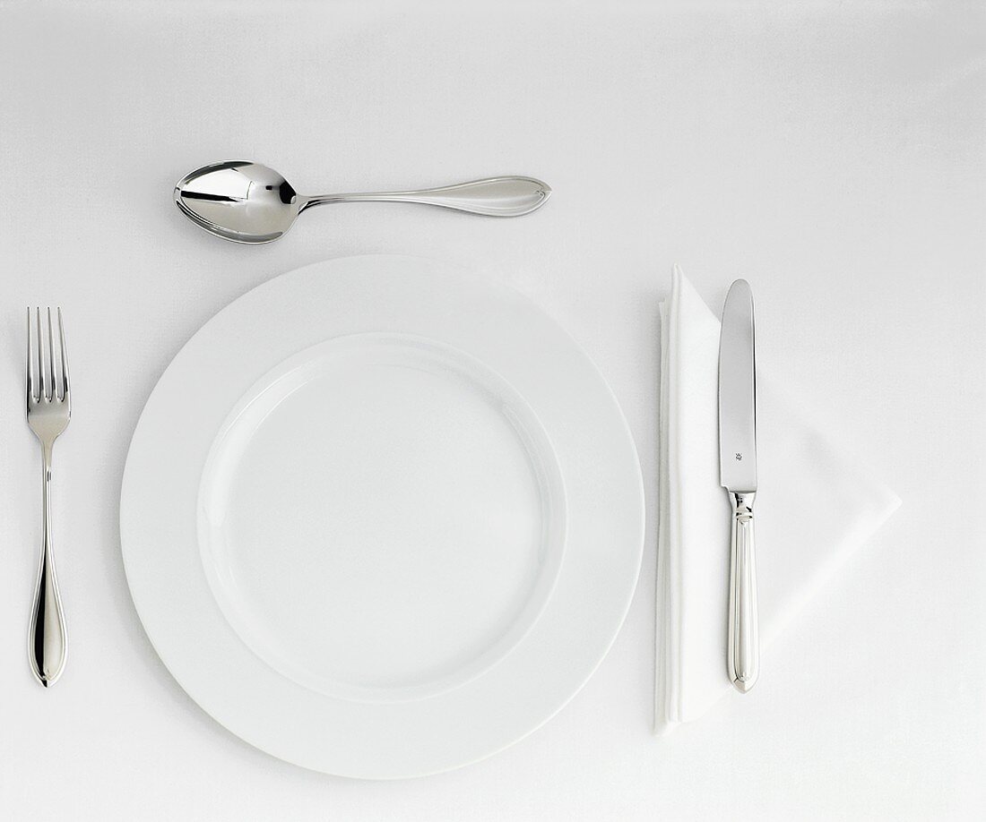 Table Setting with White Plate, Cutlery & Triangular Napkin