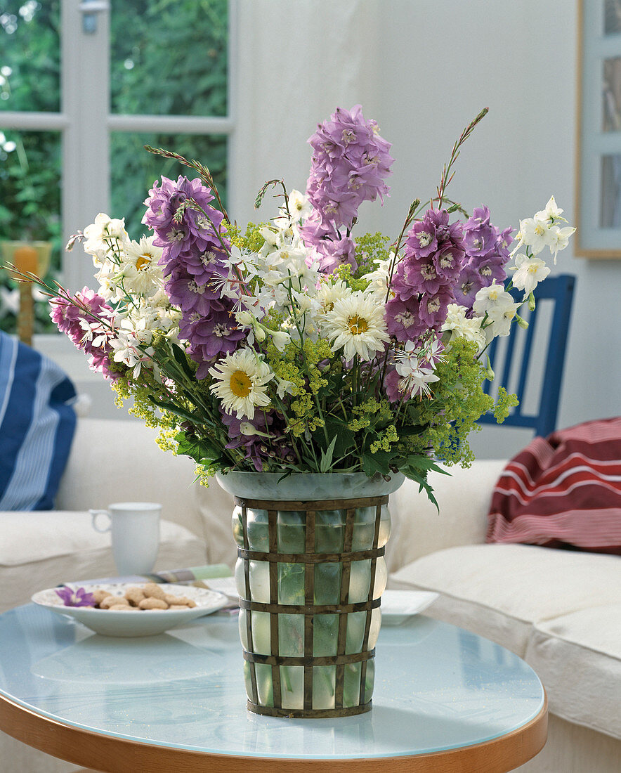 Bouquet of larkspur, daisies, lady's mantle and magnificent candle