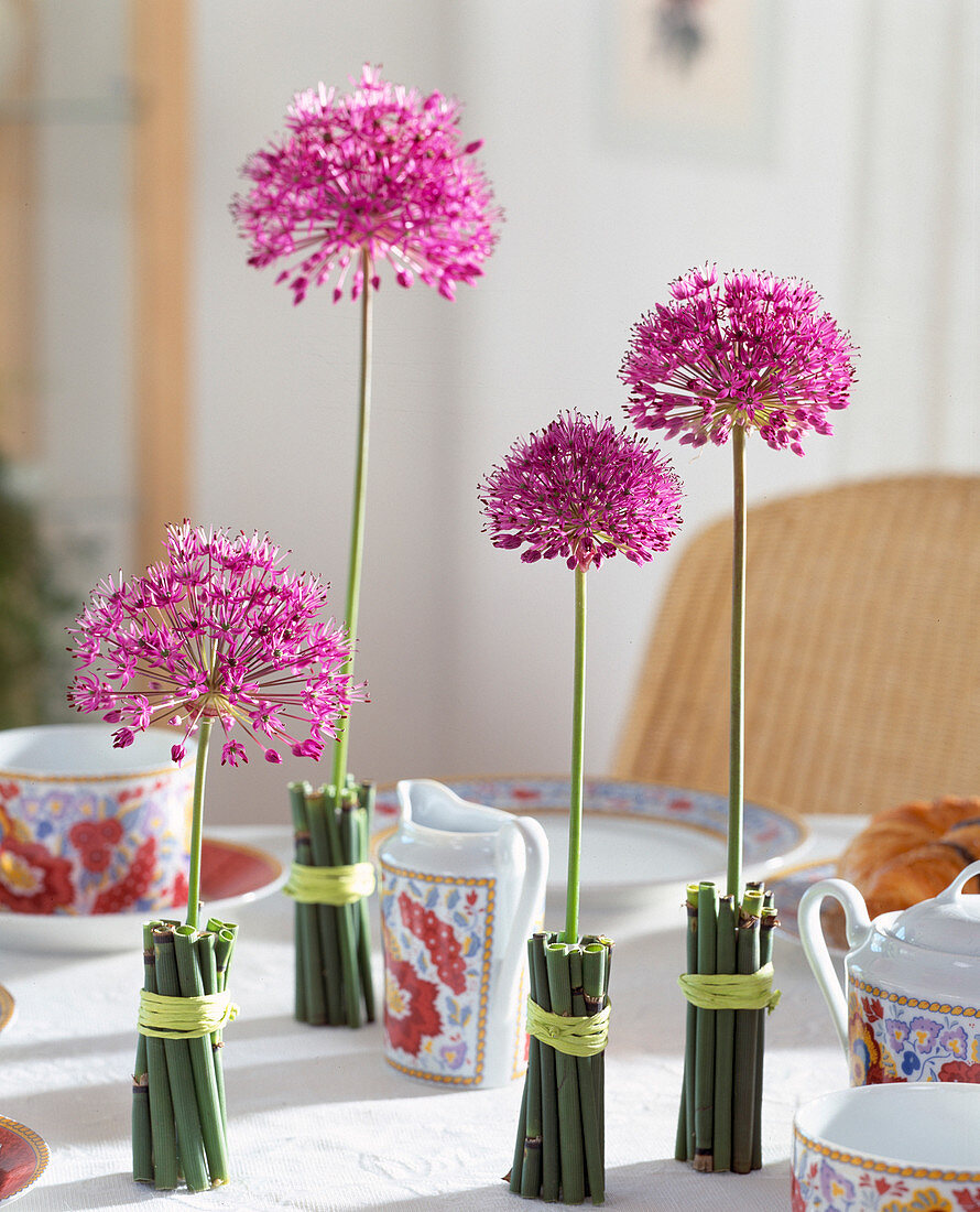 Vase wrapped in marsh horsetails and Allium