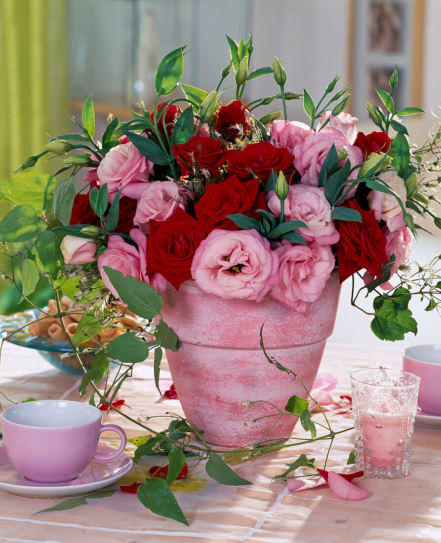 Red roses and eustoma (prairie gentian), clematis tendril