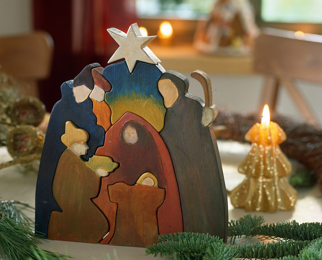 Christmas cot made of painted wood as a puzzle