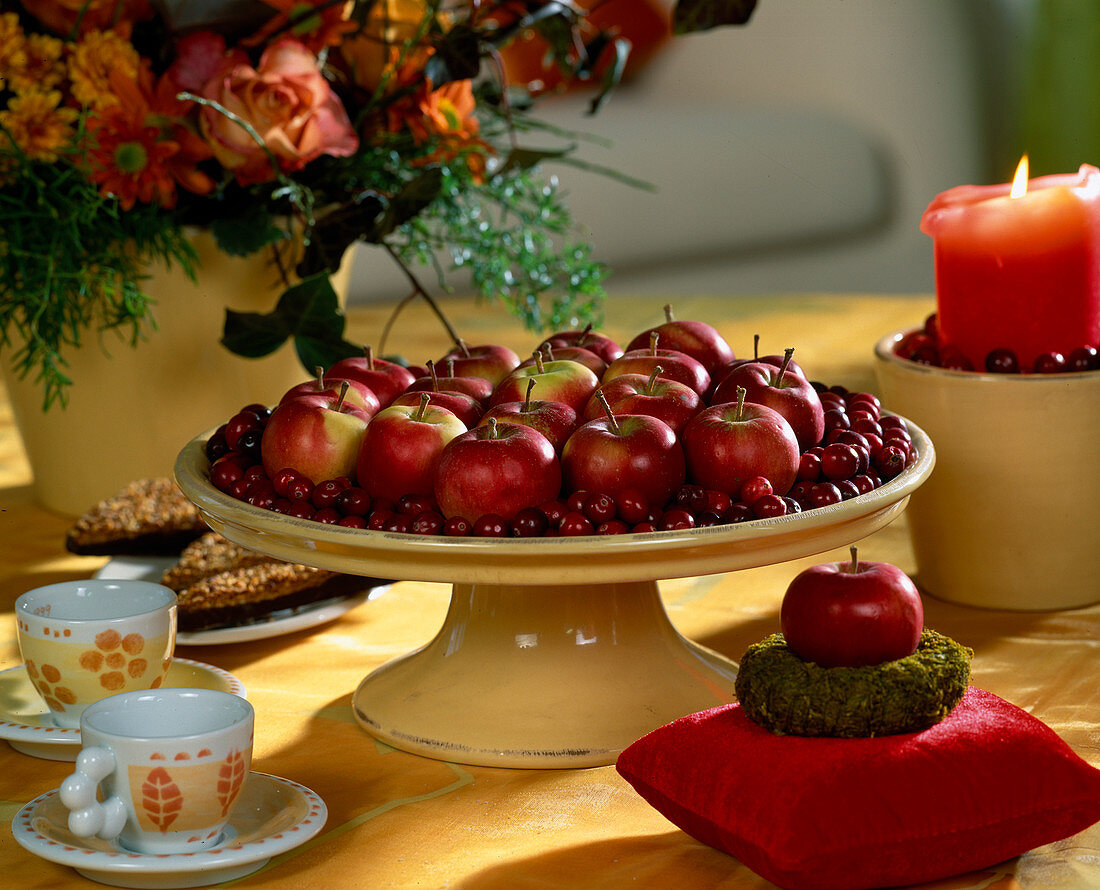 Table decoration bowl with Christmas apples and cranberries