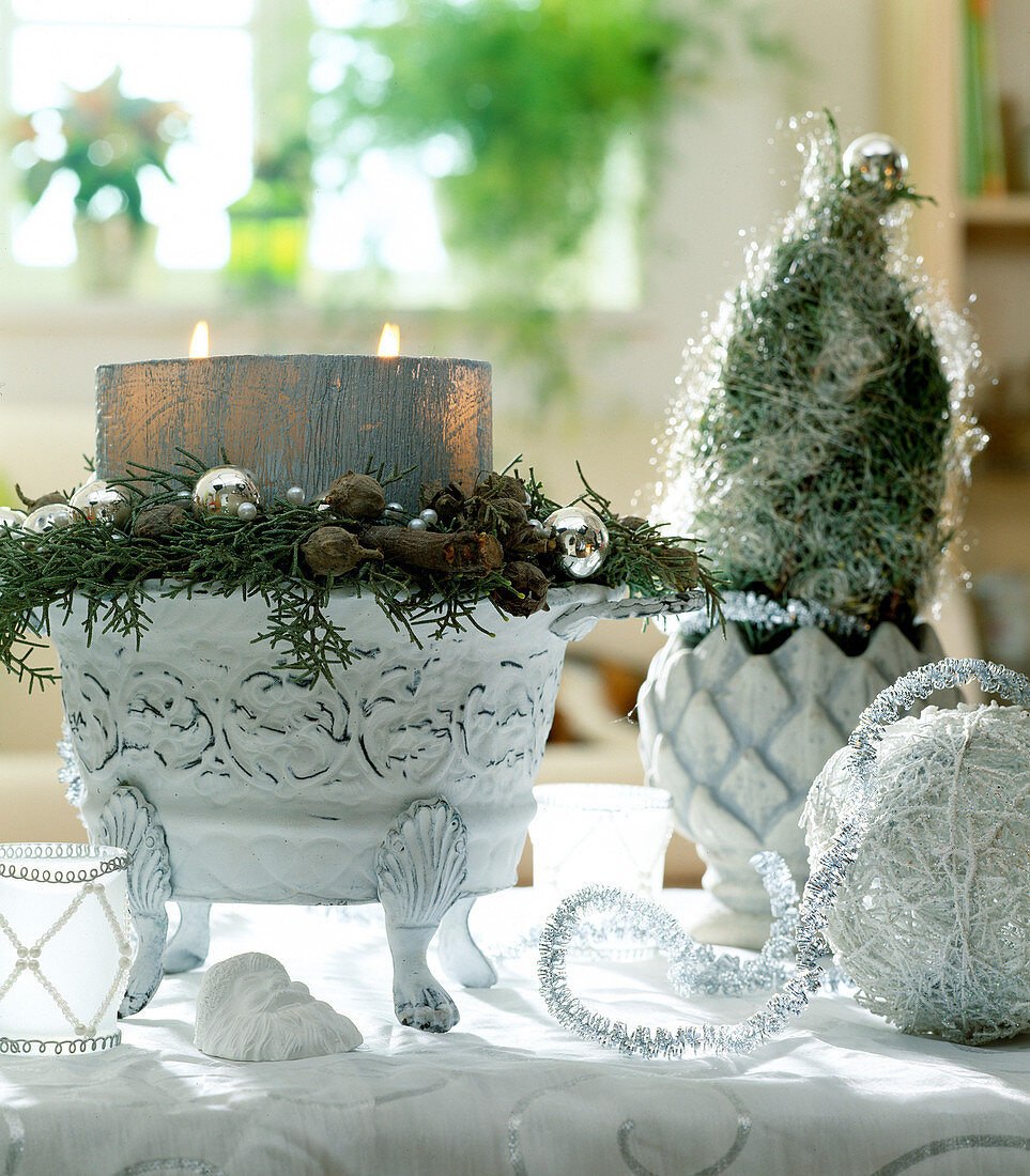White-silver design: bowl with candle, cupressus (cypress twigs)