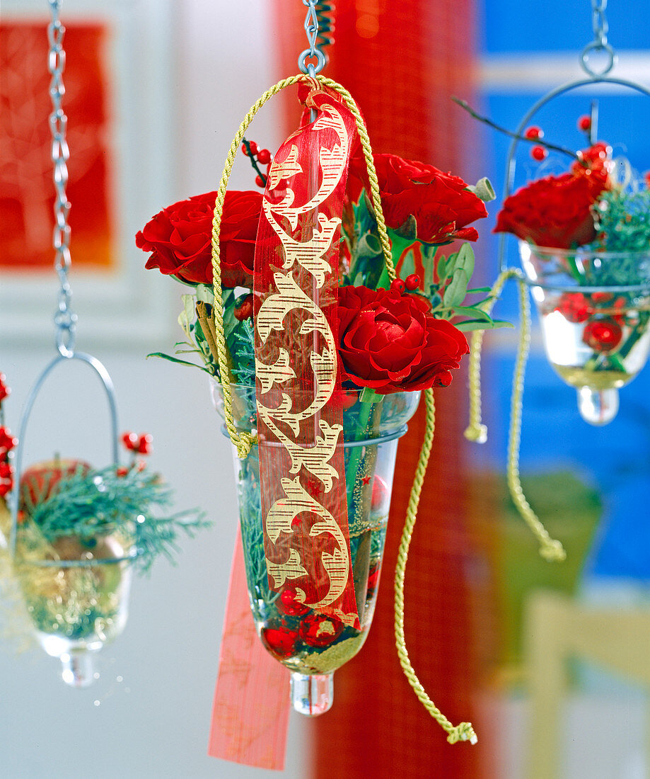 Hanging glasses with rose petals, glass balls, twigs