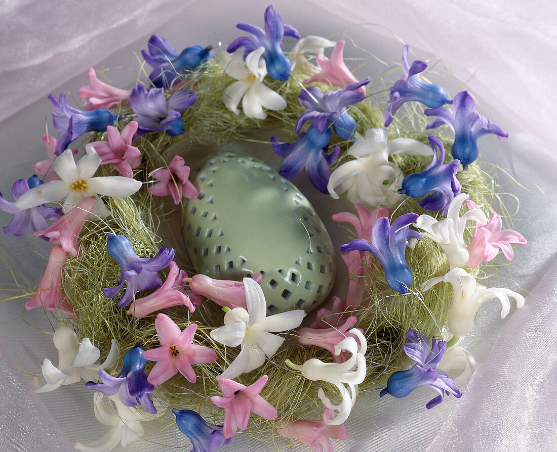 Ceramic egg in wreath with hyacinth flowers